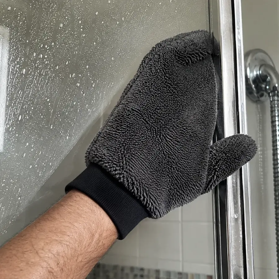GloveIt pressed flat against shower glass, clear dry glass behind it