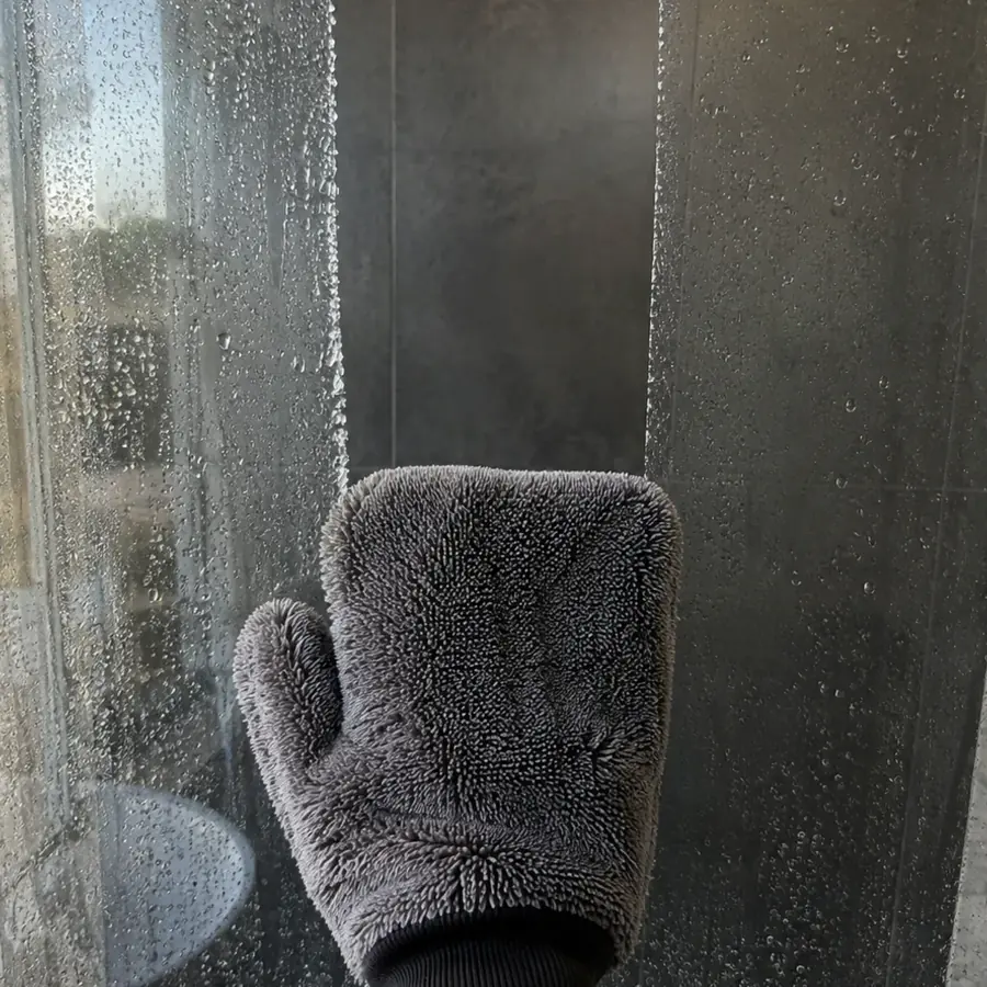 Pulling the GloveIt mitt down the shower glass in one stroke