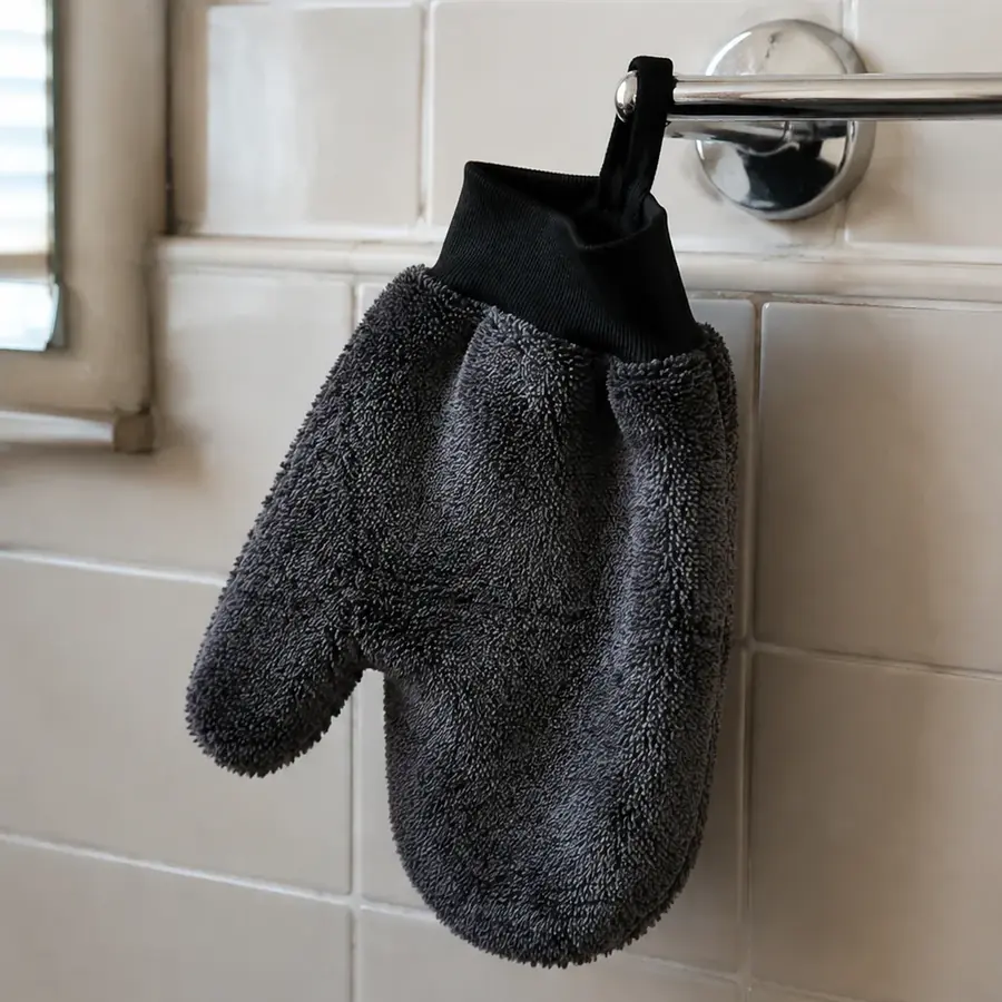 The GloveIt mitt hanging to dry on a chrome towel rail